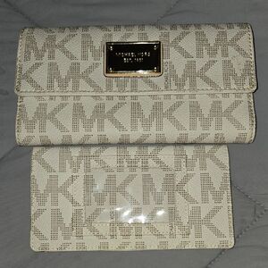 Michael Kors Jet Set signature checkbook wallet in a vanilla/white logo.